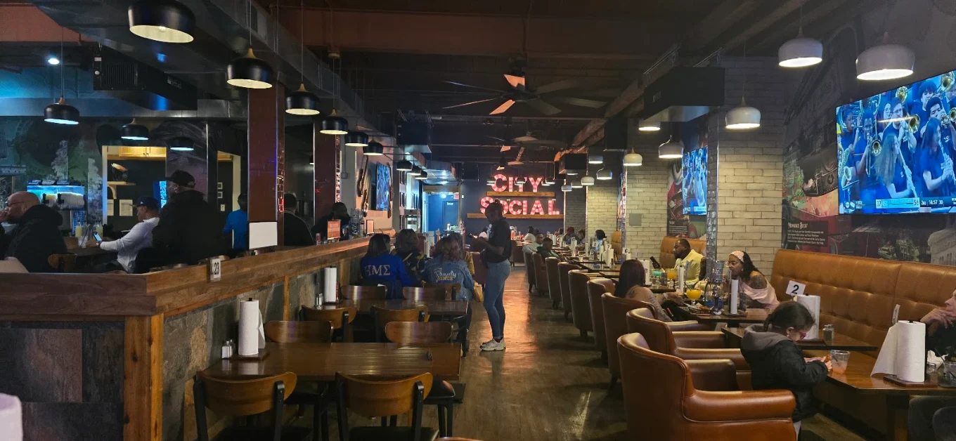 City Social dining room with blue lighting and polished tables